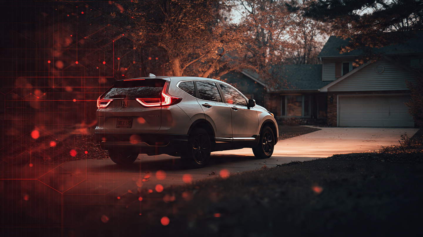 Honda CR-V parked in suburban driveway at dusk with moody lighting