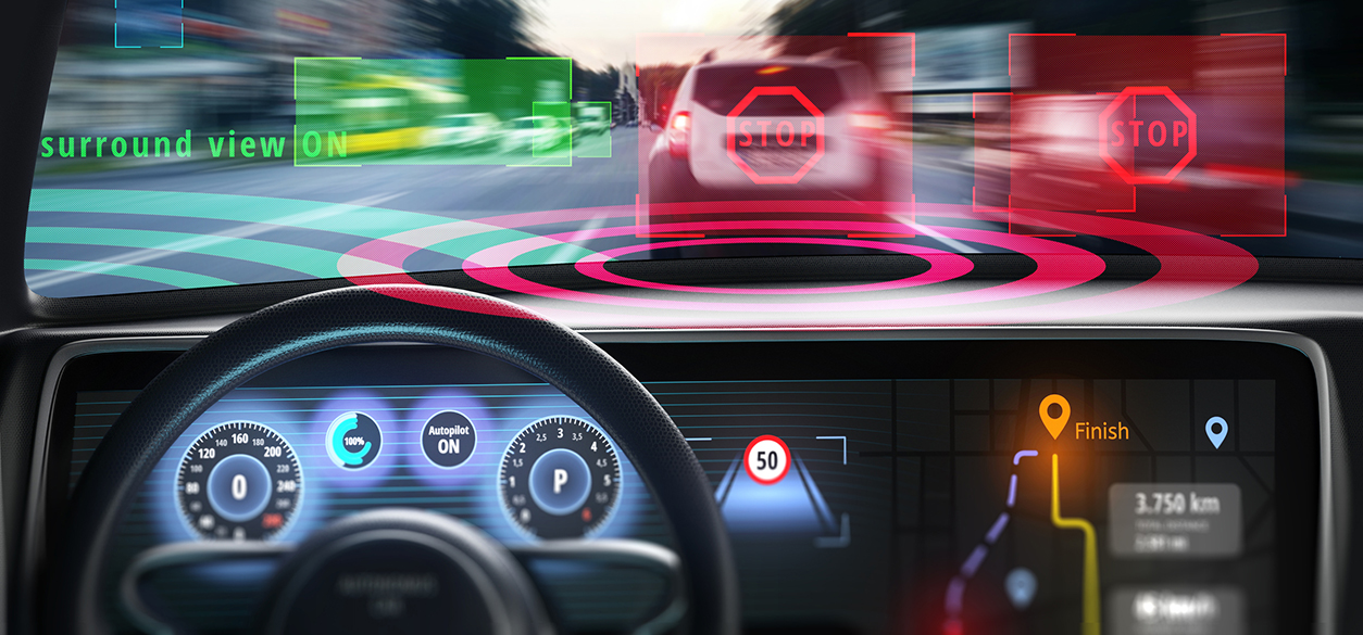A car dashboard showing autonomous driving display with a crash scene beyond the windshield