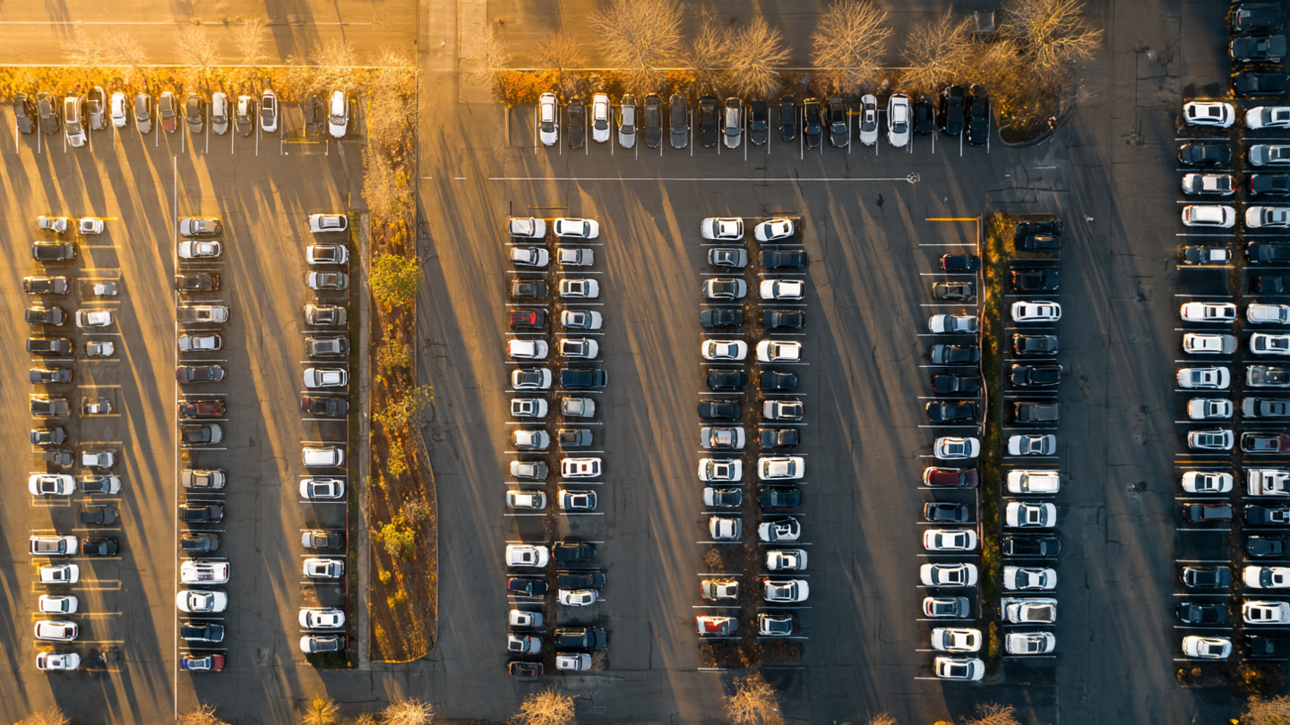 An empty sedan parking lot fading into a sea of crossover SUVs