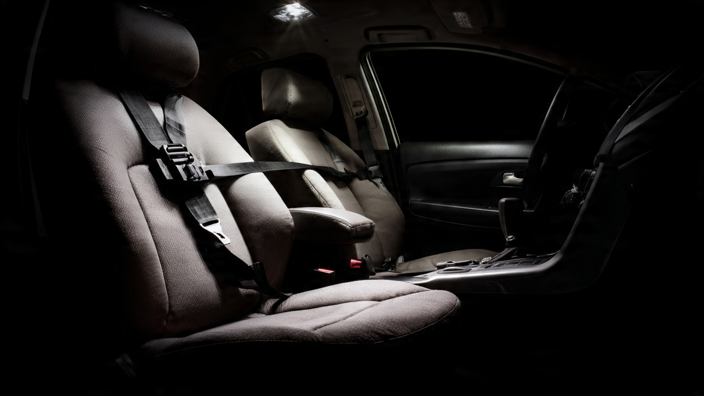 Crash test dummy in rear seat of small car showing submarining failure mode during IIHS moderate overlap test